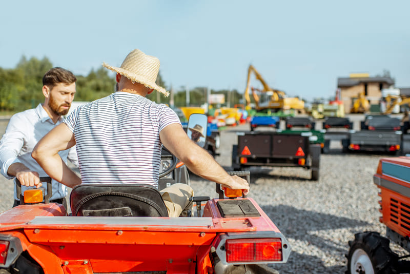 A compact tractor showcasing various customization options, highlighting attachments and features for enhanced functionality.