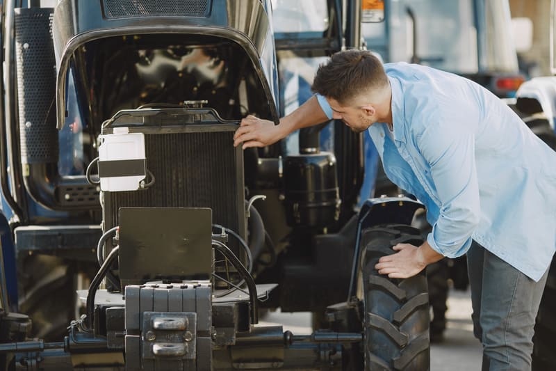 A powerful farm tractor equipped with a robust diesel engine, designed for agricultural tasks and heavy-duty performance.