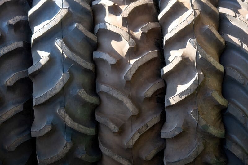 Close-up of farm tractor tires showcasing their rugged tread and durable design for optimal traction on various terrains.
