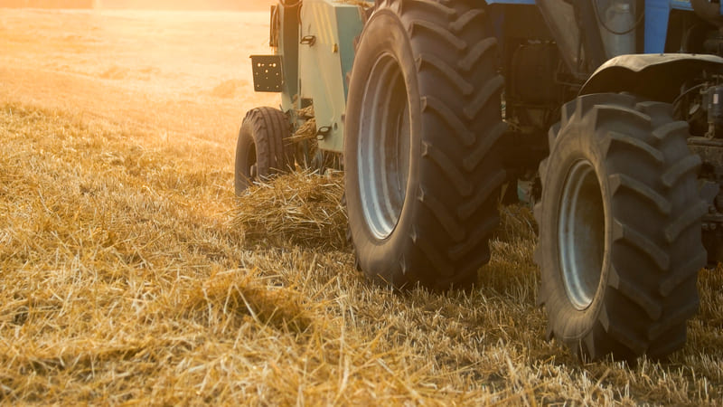 Close-up of large, rugged farm tractor tires with deep treads for enhanced traction.