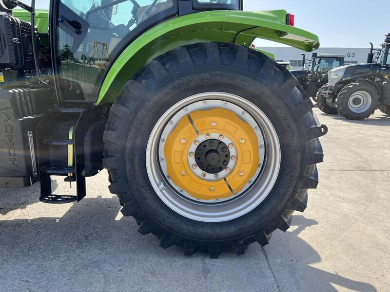 A close-up view of rugged farm tractor tires, showcasing their deep treads and robust design for agricultural use.