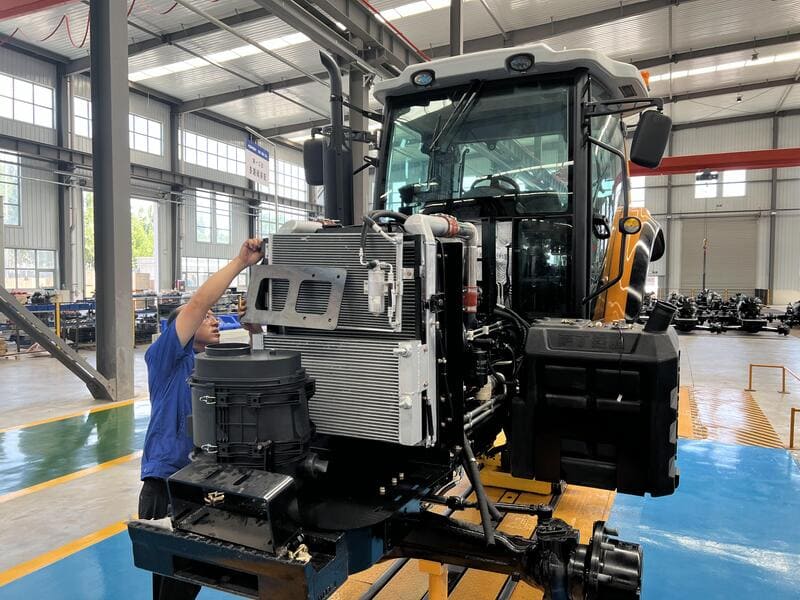 A mechanic working on a diesel tractor engine, showcasing tools and machinery in a workshop setting.