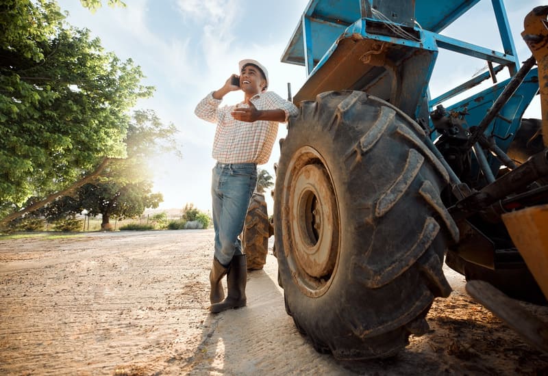 Close-up of rugged tractor tires showcasing deep treads and durable rubber, emphasizing their strength and functionality.