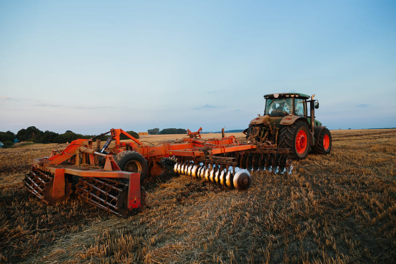 Various tractor attachments displayed, showcasing tools for farming and landscaping tasks, enhancing tractor versatility.