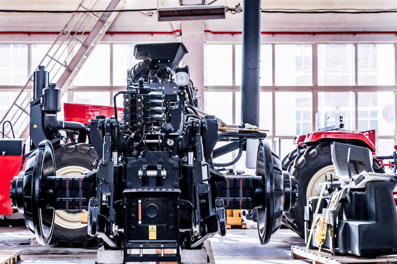 Close-up view of a tractor's diesel engine, showcasing intricate components and robust design for agricultural efficiency.