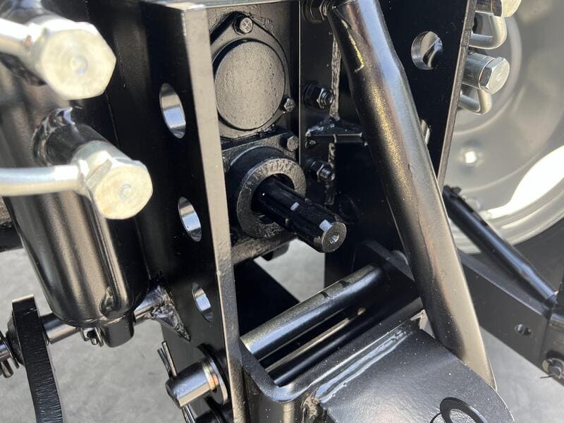 A close-up of a tractor PTO shaft, showcasing its robust design and connection points for efficient power transfer.