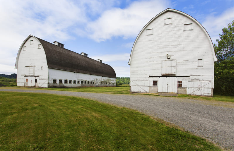 A traditional barn on a farm, used for storing equipment, livestock, and harvested crops.