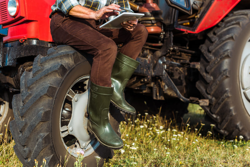 A variety of farm tractor parts, including filters, tires, and hydraulic components, displayed for purchase.