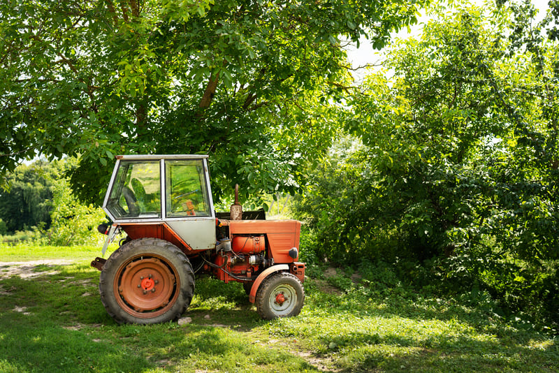 A second-hand farm tractor in good condition, displayed for resale with a focus on affordability and functionality.