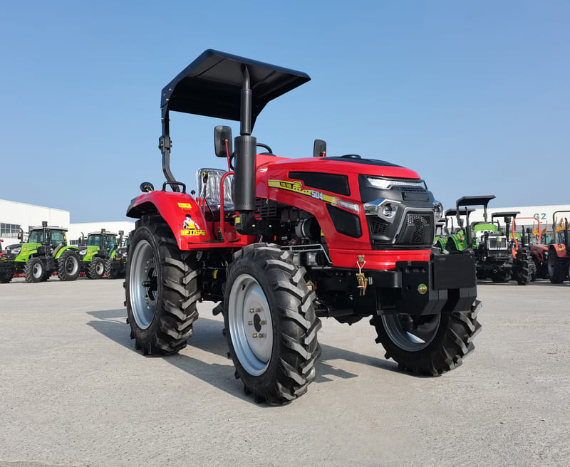 A small 50HP farm tractor parked in a field, equipped for versatile agricultural tasks such as plowing and hauling.