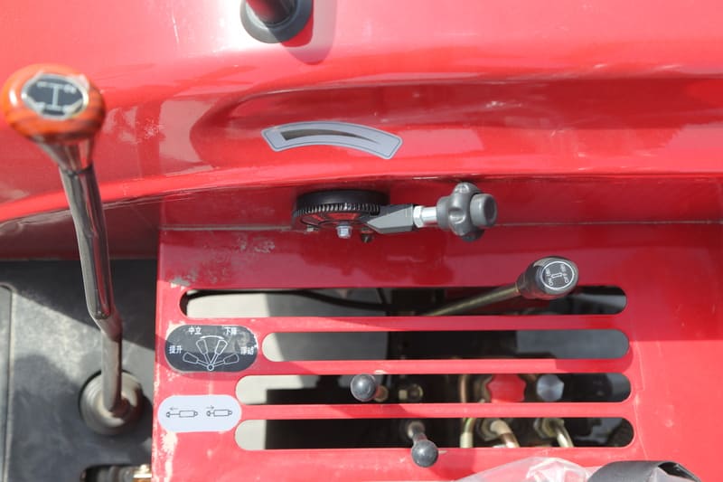 A close-up of a tractor brake system, showcasing brake pedals and hydraulic components for safe stopping.