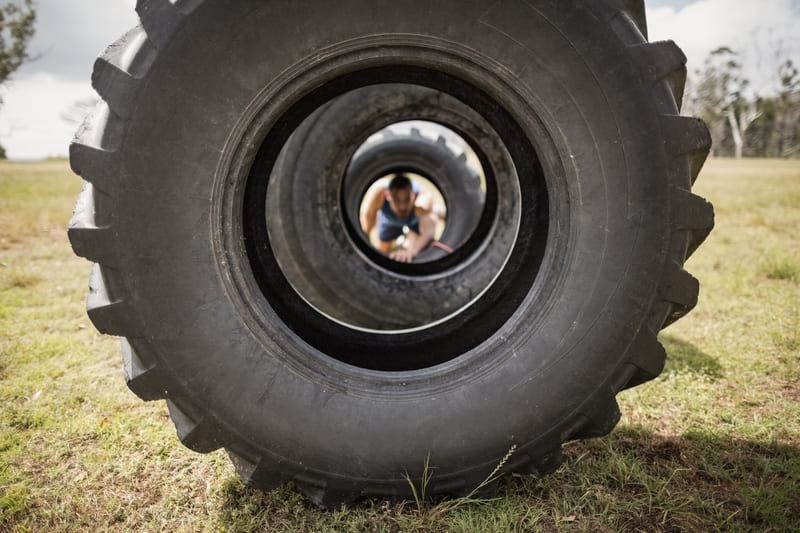 A close-up of a durable tractor tire with deep treads, designed for maximum traction on various terrains.