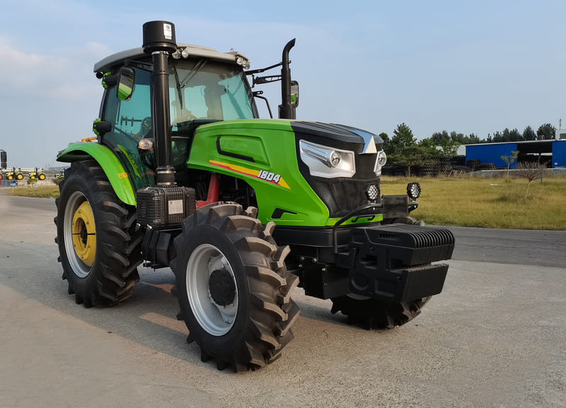A powerful 180HP farm tractor working in a large field, ideal for heavy-duty agricultural tasks.