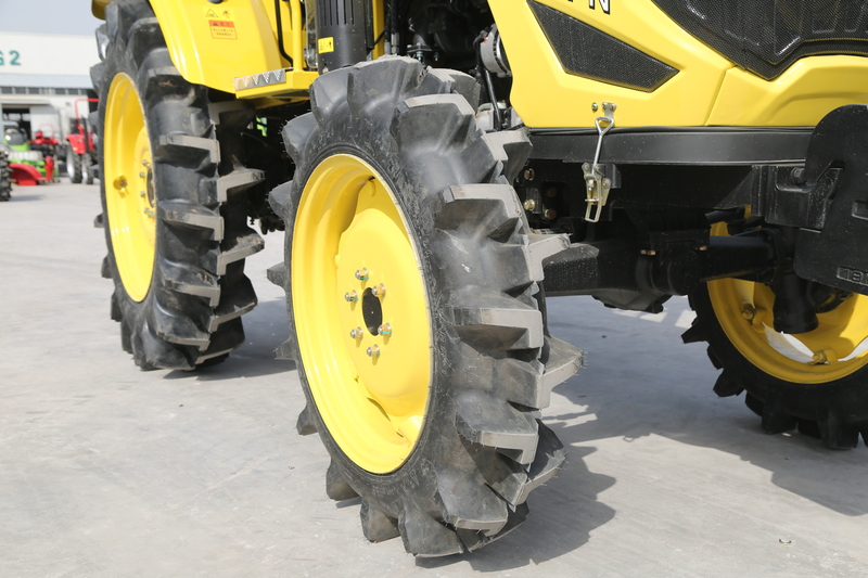 A farm tractor making a sharp turn in a field, demonstrating its maneuverability and ease of handling.