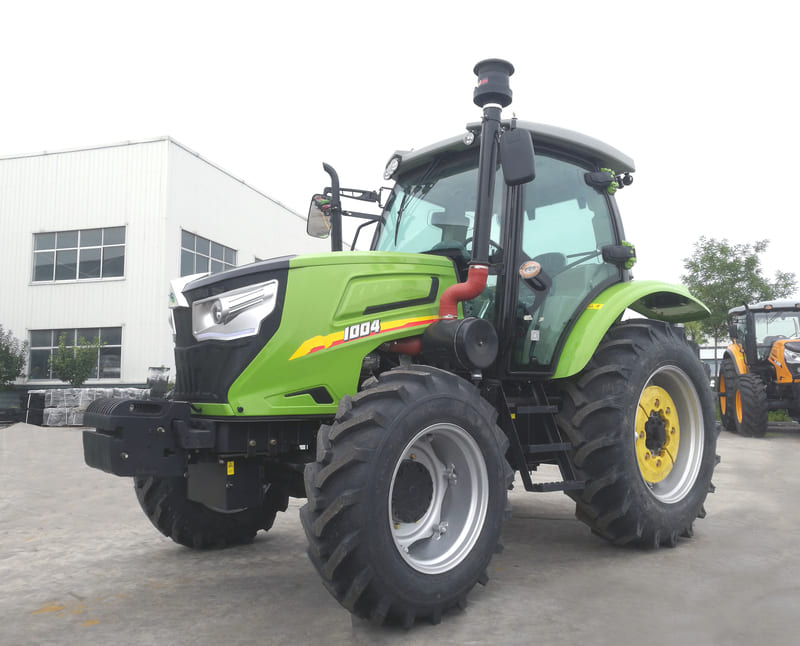 A farm tractor equipped with a fully enclosed cab, featuring wide windows, climate control, and modern operator controls for enhanced comfort and safety.