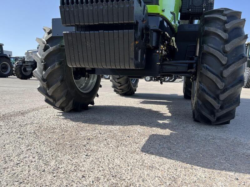 Close-up of front counterweights on a farm tractor, showing their positioning and importance in stabilizing the machine during heavy work.